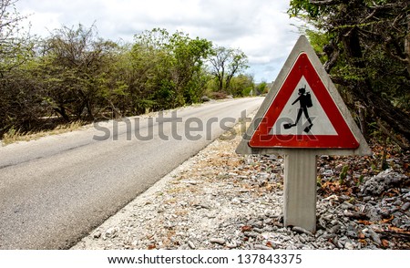 a traffic sign warning drivers about divers crossing the road