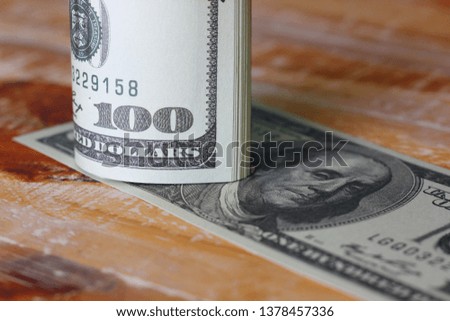 American dollars in roll pattern on wood floor