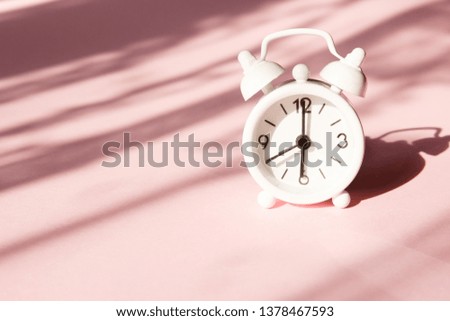 Alarm clock on pink background. Morning time background concept