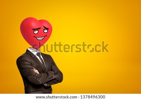 Businessman with red cartoon smiley heart instead of head on yellow background. Digital art. Feelings and emotions. Business and life.