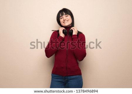 Young woman with red turtleneck with headphones
