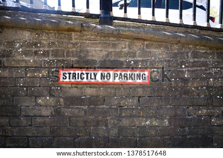 Strictly No Parking Sign on brick wall in Saltaire, United Kingdom