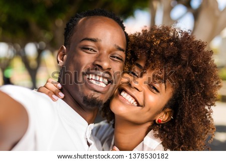Outdoor protrait of black african american couple  taking a selfie Royalty-Free Stock Photo #1378530182