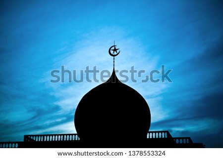 Silhouette of Islamic mosque onion dome with blue sky on sunset time