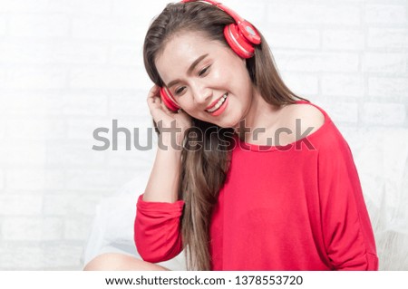 Relaxed young woman listening to music in headphones with her happy, in concept lifestyle.