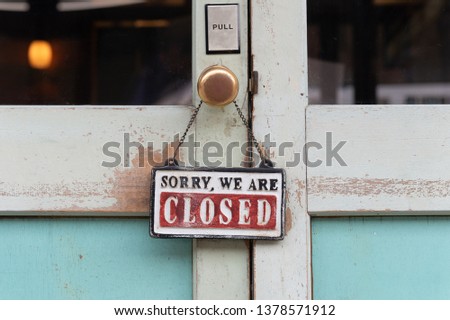 sorry we are closed sign hanging outside a restaurant, store, office or other Royalty-Free Stock Photo #1378571912