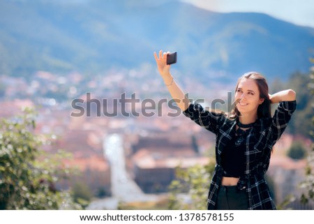 Female Tourist Taking Selfies in front of Beautiful Panoramic View. Funny woman taking photos for social media in summer holiday
