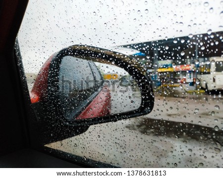 Raindrops on the glass of a car, focus on raindrops. Blurred window 