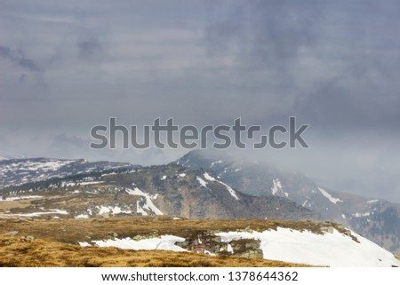 Dramatic game of shadow and light before the storm on the highlands of Old mountain in Serbia and misty, moody sky