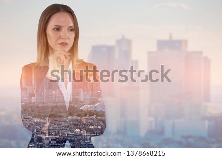 Double exposure image of businesswoman on cityscape background