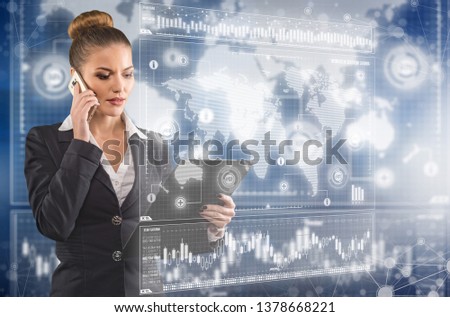 Young business lady speaks on the phone and works in futuristic office