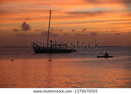 Caye Caulke, Belize - February, 2019: Incredible Caribbean sunset in Belize. The colors during sunset in Key Caulaker islands are amazing.