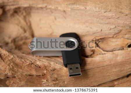 folding metallic and black usb drive on a wooden background