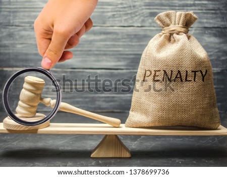 Bag with the word Penalty and gavel on the scales. Penalty as a punishment for a crime and offense. Fraud. The court's decision. Appeal. Cancellation of fines and financial penalties. Litigation Royalty-Free Stock Photo #1378699736