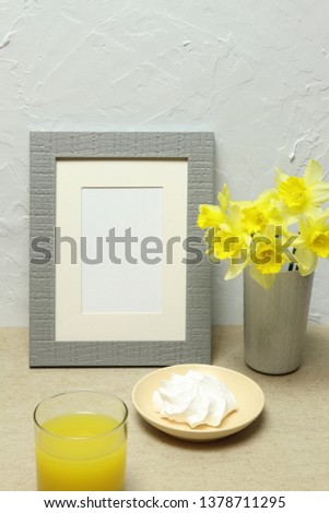 Mockup photo frame with healthy food, yellow flowers on stone background