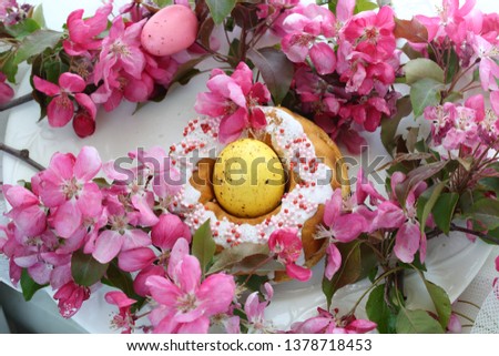 Still life with Easter cakes, painted eggs and a bouquet of flowering branches
