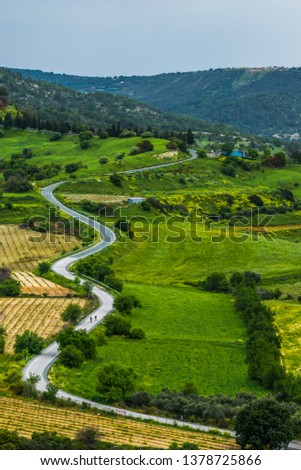 Wavy road with lots of curves in Cyprus, spring landscape and green grass towards Troodos Mountains, Paphos area