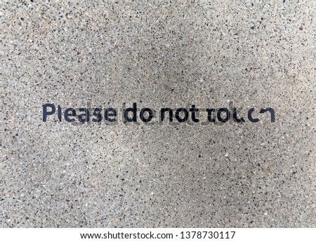 Deteriorating sign on the ground, Please do not touch