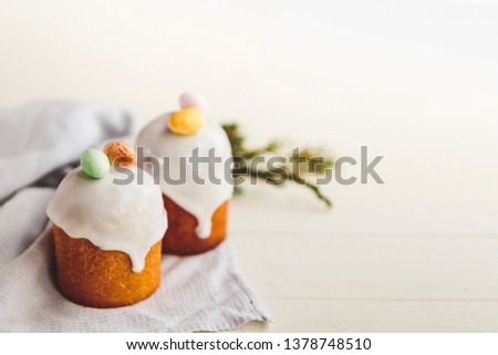 Happy Easter background with an easter bread decorated with glaze, chocolate and little eggs. Picture for greeting card, ad, promotion, poster, flyer, article. complex composition, beautiful scenery
