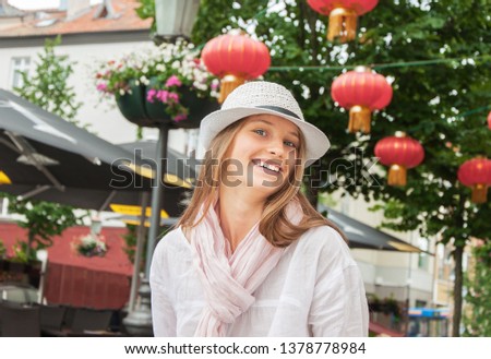 Happy cheerful smiling girl at the chinese restaurant
