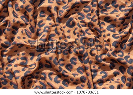 Leopard pattern texture. Textile, silk, crumpled.