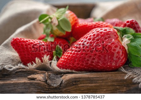 Beautiful ripe strawberries for sale on a tray in wooden containers. without plastic