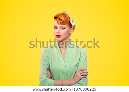 Arrogant. Closeup portrait beautiful businesswoman looking with arrogance at camera arms crossed, folded isolated yellow background wall.  Pinup girl retro vintage 50s style. Negative face expression Royalty-Free Stock Photo #1378808225