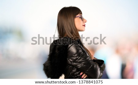 Woman with glasses in lateral position at outdoors