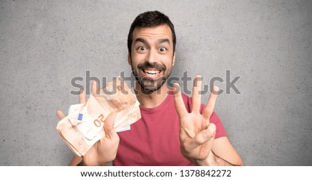 Man taking a lot of money counting eight with fingers over textured wall
