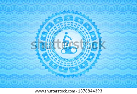 stationary bike icon inside light blue water wave badge.