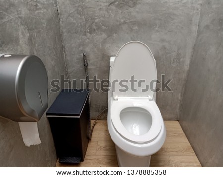 The bathroom in the resort consists of a toilet bowl, trash bin and tissue.