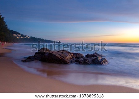 The scenery of beautiful sunset with natural rocks during twilight sky background. Long exposure water shooting