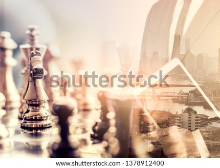 The double exposure image of the businessman standing overlay with chess game image. the concept of strategy,intelligence and education.