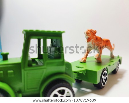 Green Farm Tractor Trailer Friction Children Kid Toy Truck and tiger Isolated on white background