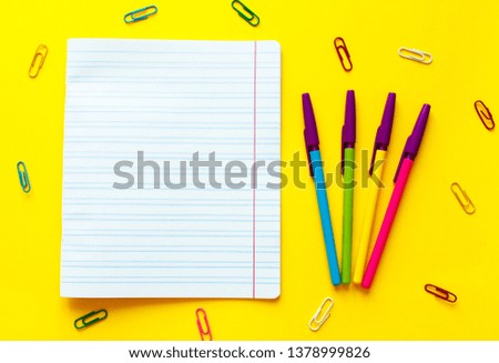 Back to school concept with space for text. Top view. Copy space. School office supplies.Creative desk with colourful stationery. Colored paper clip.School supplies on yellow background.Office desk.