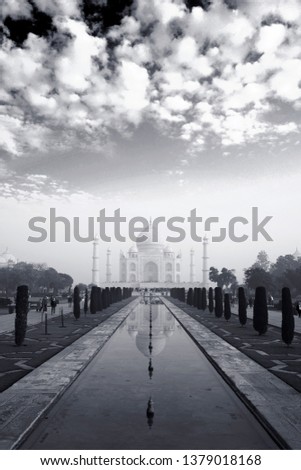 Clouds above Taj: The picture shows the white morning clouds over beautiful Tajmahal and its perfect reflection.               