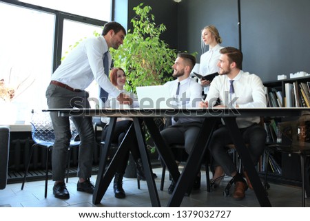 Businessman shaking hands to seal a deal with his partner and colleagues in office.