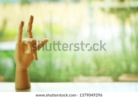 Wooden hand symbol for love and free copy space for Happy Valentine’s Day background idea concept. Selective focus and toned image.