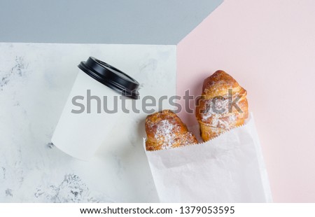 Fresh Croissants with coffee to go in a paper cup on tricolor background. Take away breakfast. Minimalism concept. Flat lay, place fo text Royalty-Free Stock Photo #1379053595