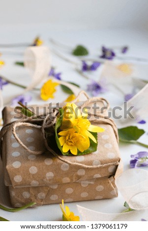 gift box with spring flowers. modern craft present wrapping. polka dot