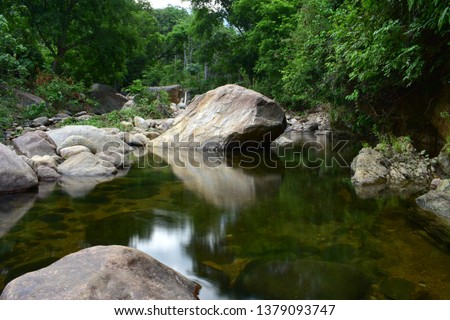 Rock Reflection On River
