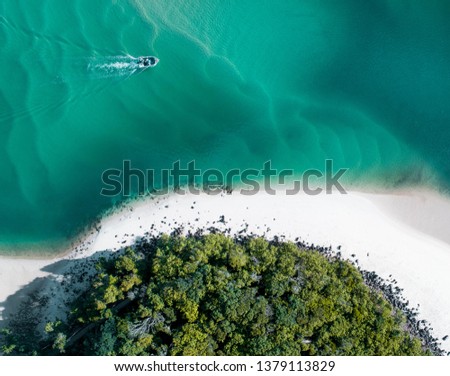 Beach aerial summer with boat and blue tropical water. Beautiful gold coast hot drone shot with boat and sand drift.