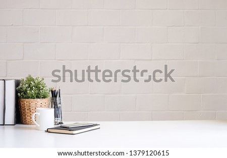 Cropped shot view of Mockup workspace desk and copy space books,plant and coffee on white desk. Royalty-Free Stock Photo #1379120615