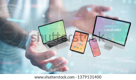 Businessman on blurred background connecting modern smartphone tablet laptop and computer 3D rendering