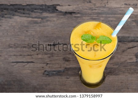 Mango smoothies yellow colorful fruit juice milkshake blend beverage healthy high protein the taste yummy In glass,drink to lose weight drink episode morning on wooden background.