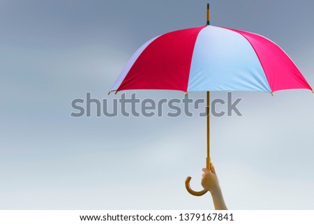 Protection concept: hand holding rainbow umbrella distinctively unique
