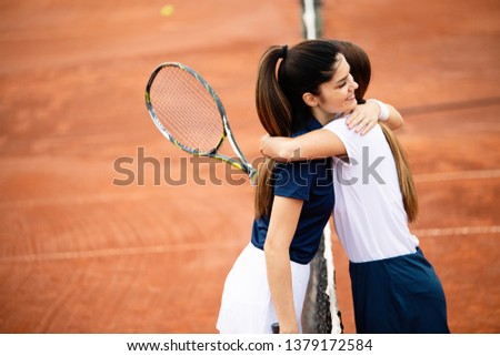 Women tennis player handshaking after playing a tennis match. Fairplay, sport concept. Royalty-Free Stock Photo #1379172584
