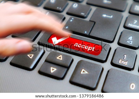 Black keyboard with ACCEPT button.Finger pushing the Accept button on laptop computer.Technology,internet concept.                                                                                  