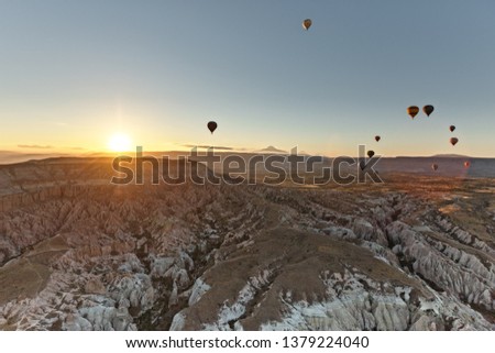 Hot Air Balloons Flying Over Cappadocia Turkey at sunrise.