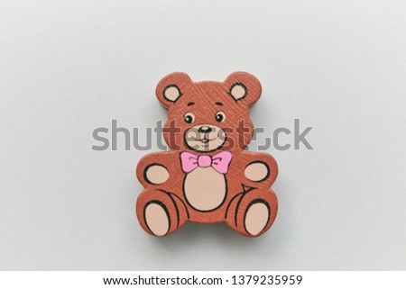 Children's wooden retro toy Teddy bear alone on a light background. space for text. copy space.
